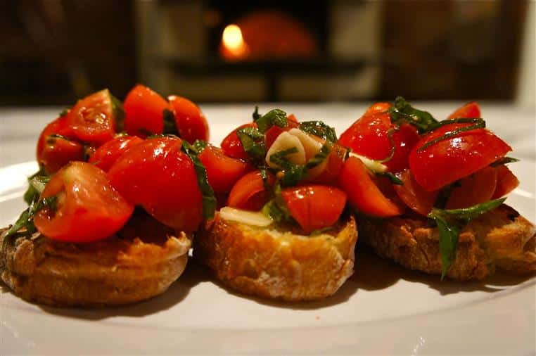 tomato and basil on top of small slices of bread