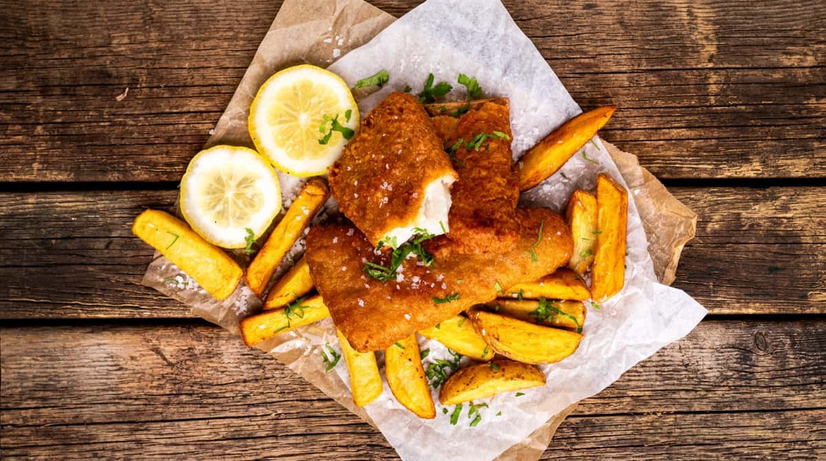 Crispy fish and chips served with lemon and fresh herbs.
