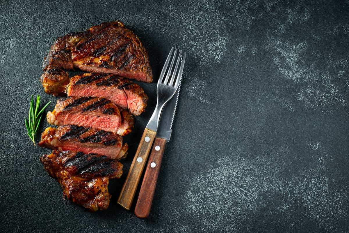 sliced steak with fork and knife