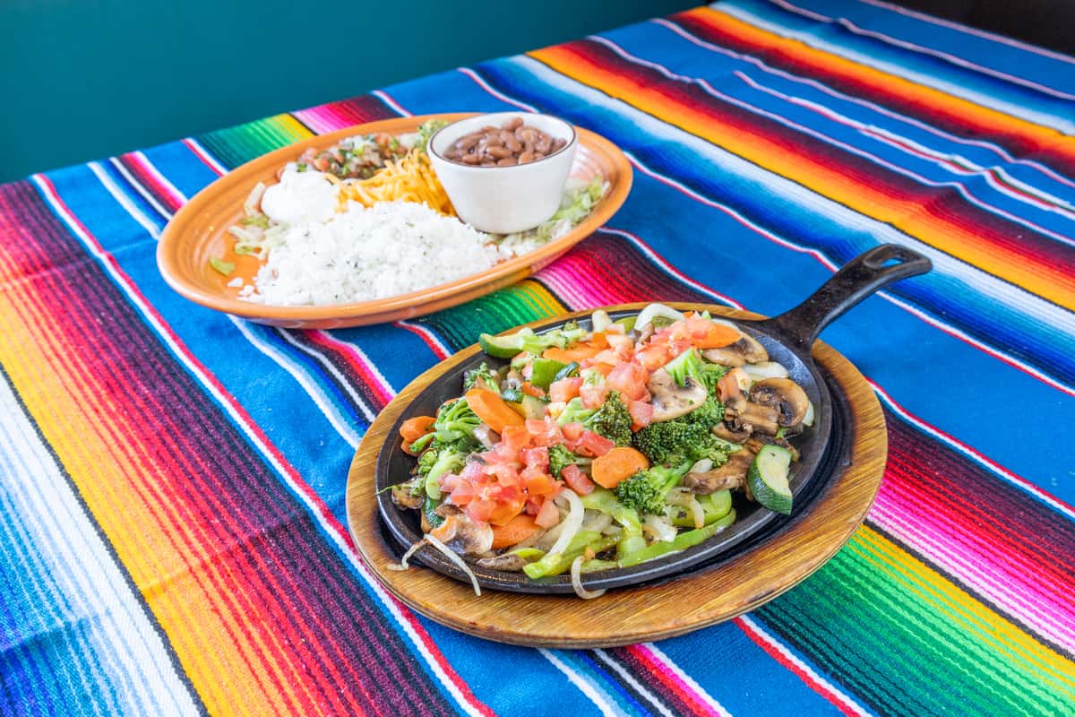 Veggie Fajitas dish with a skillet next to it