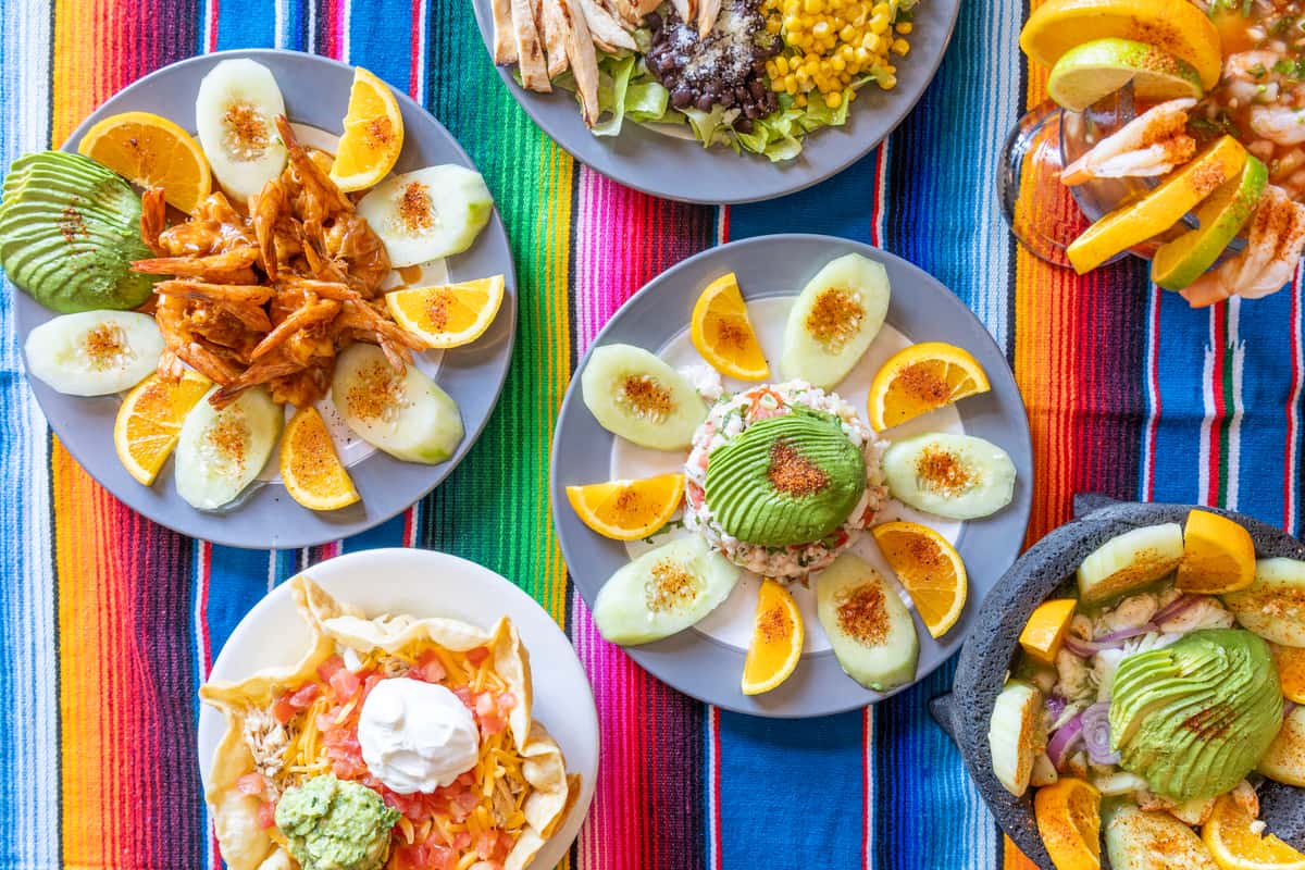 Hero image of various Mexican dishes on a traditional Mexican blanket