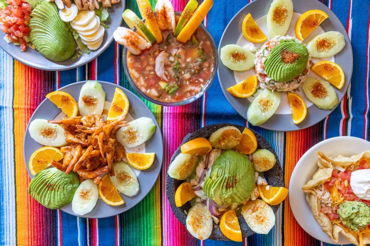 Hero shot of multiple Mexican dishes on a traditional blanket
