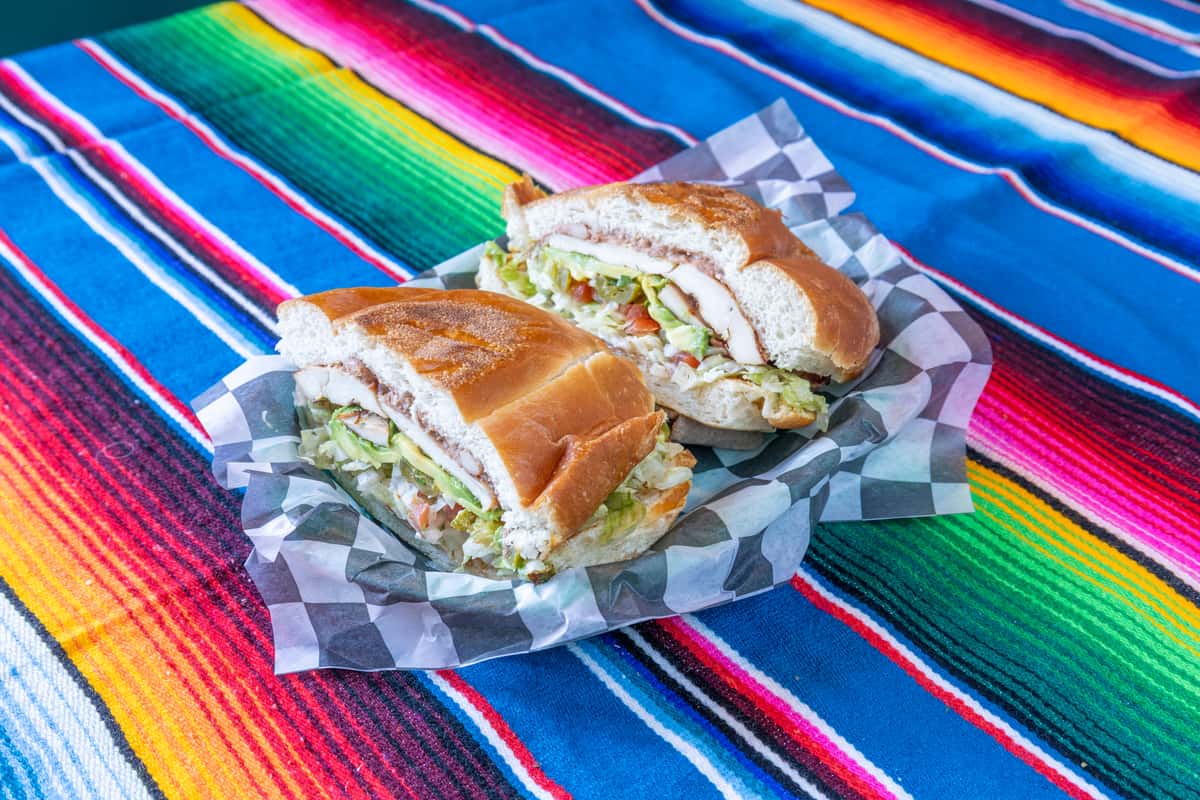 Torta cut in half on takeout parchment paper