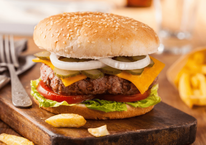 cheeseburger with pickles, onions, tomatoes and lettuce