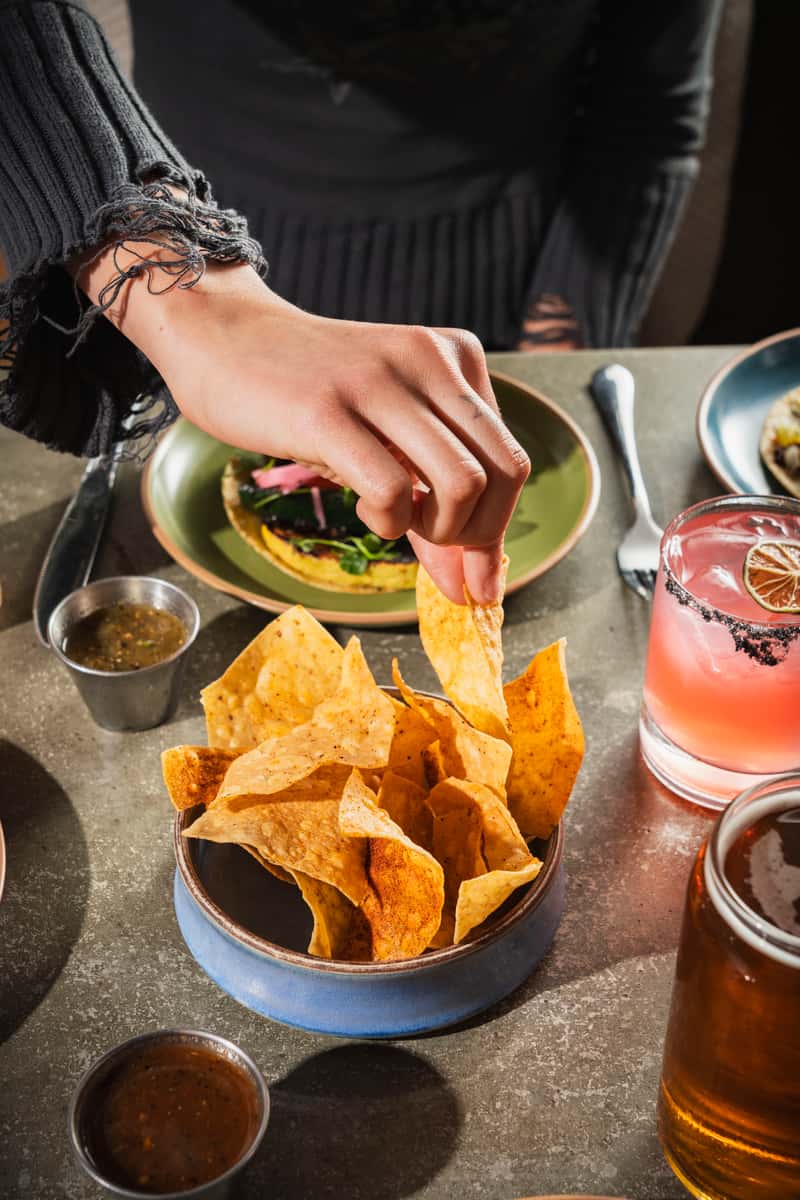 getting nachos from bowl