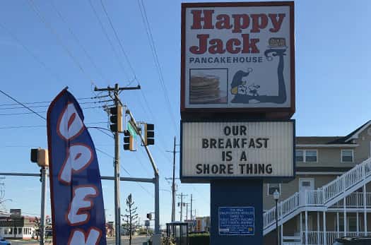 Happy Jack Pancake House sign outside the business with a marquee sign below. Our breakfast is a shore thing