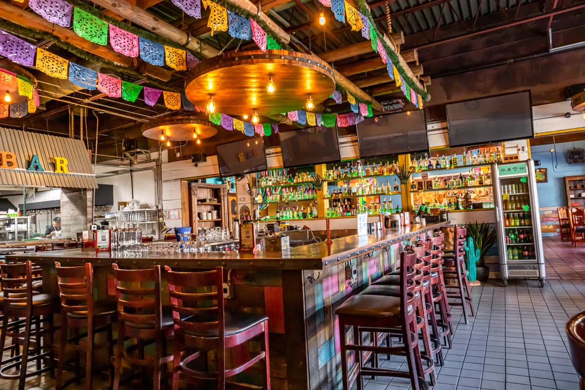 Fernando's Tequila Bar with bar seating and colorful hanging decorations