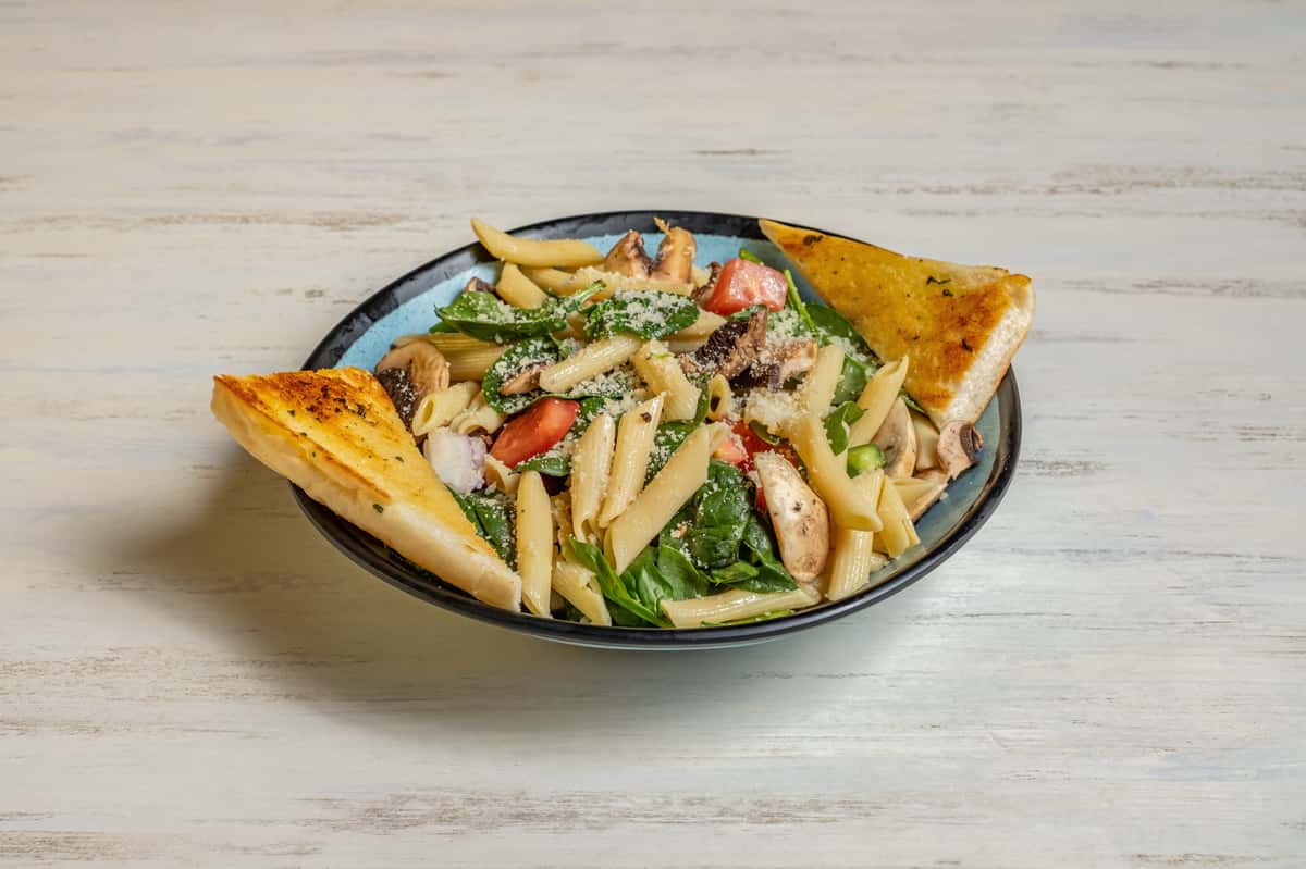 Penne pasta, mushrooms, spinach, sun dried tomatoes, peppers, onions, garlic, white wine sauce
