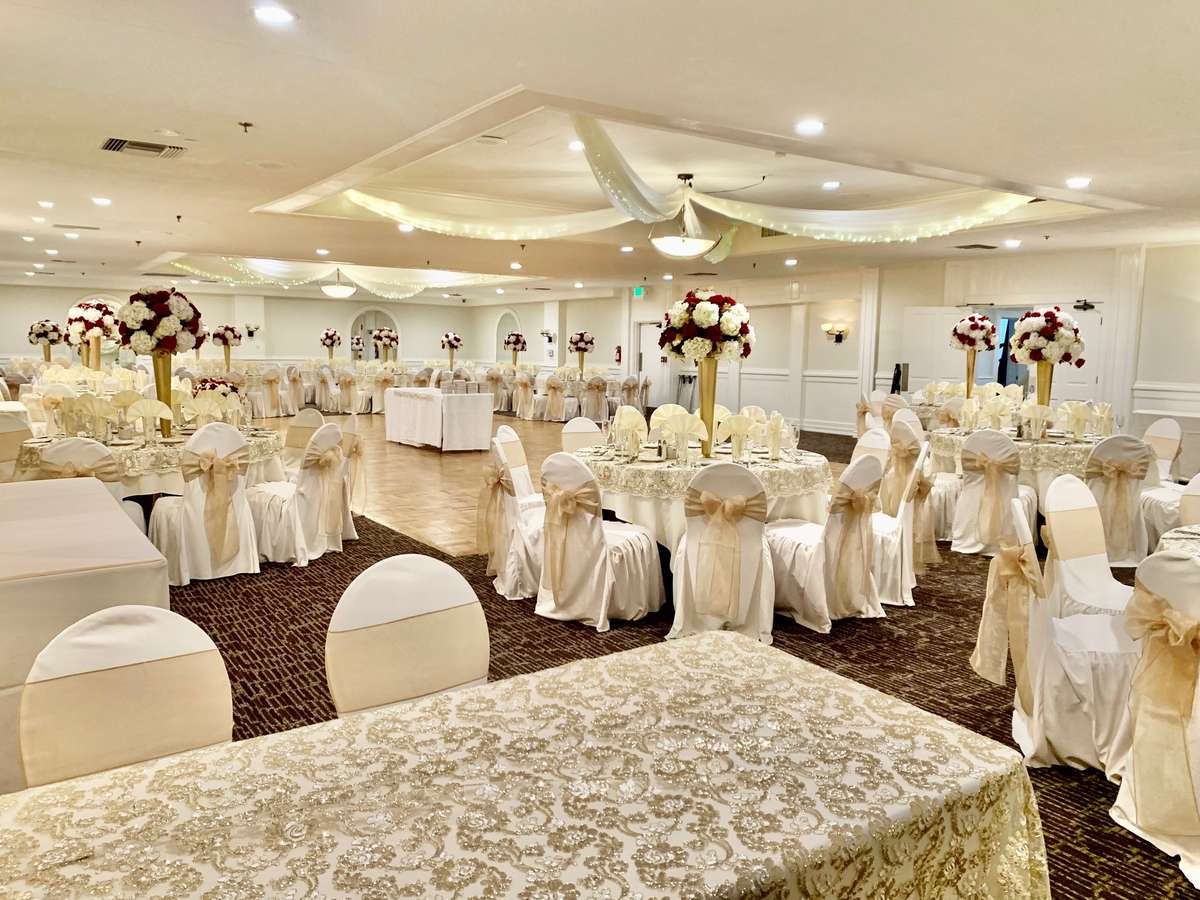 an event space with rectangle and circular tables decorated for a wedding