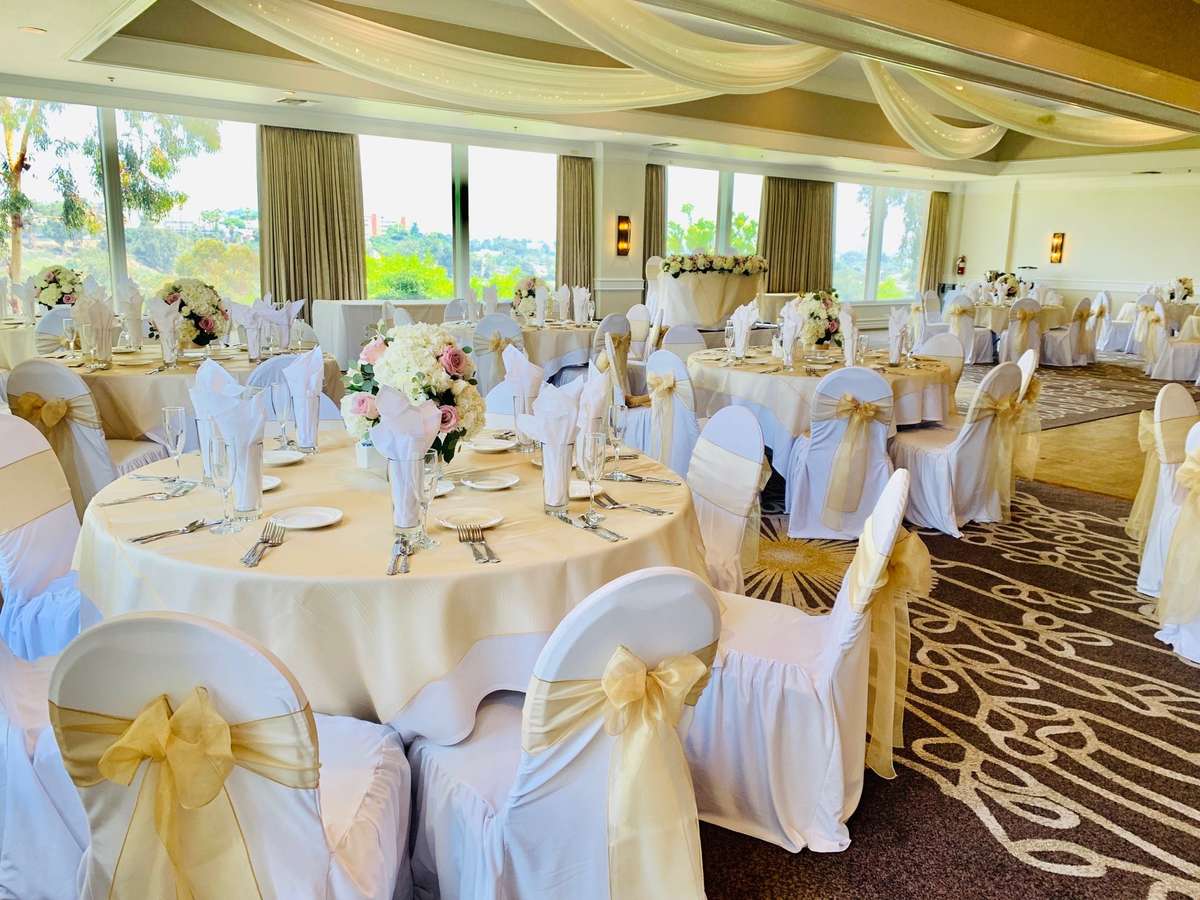 an event space with decorated round table settings for a wedding