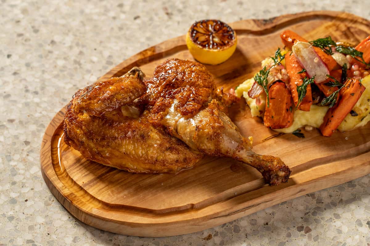 roasted chicken on a wooden cutting board