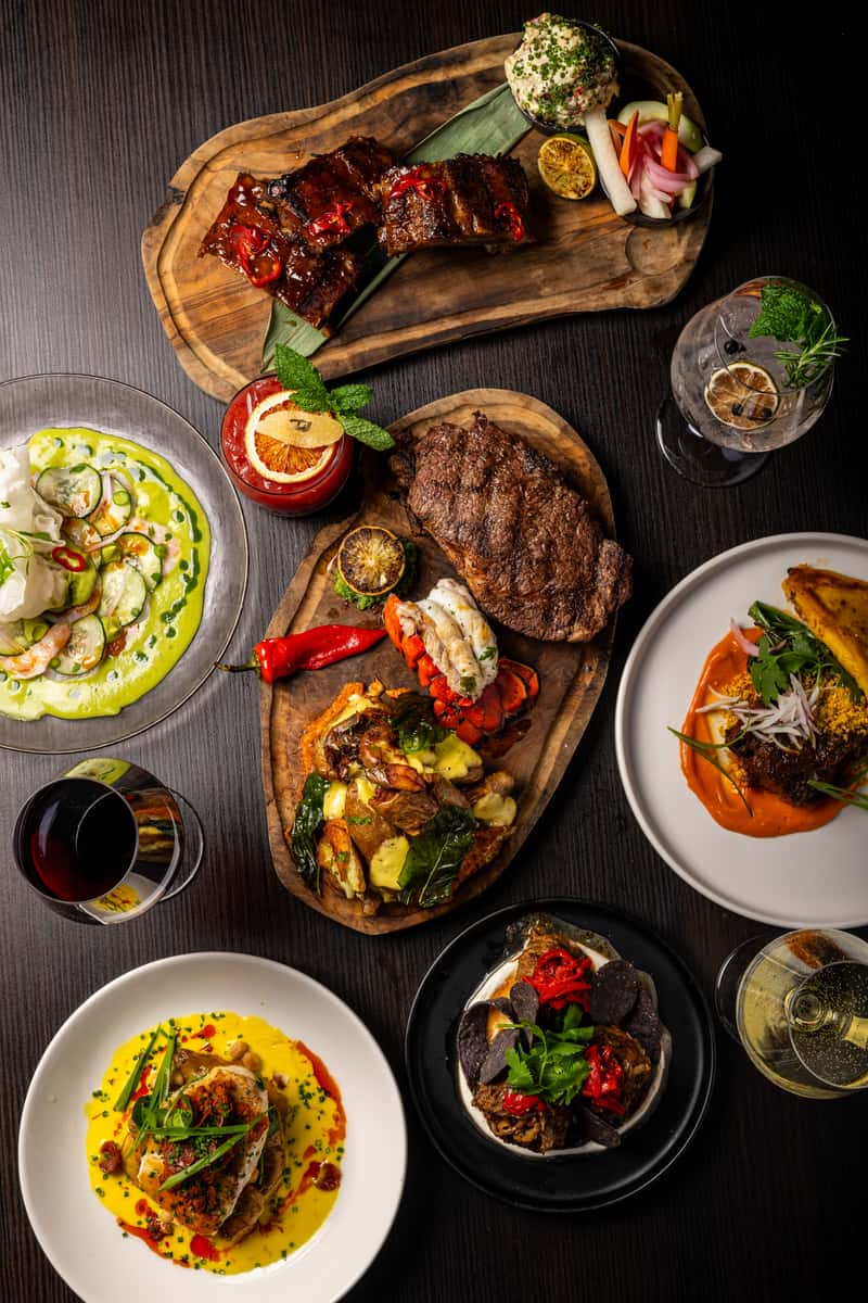 tablescape of food including steak and fish