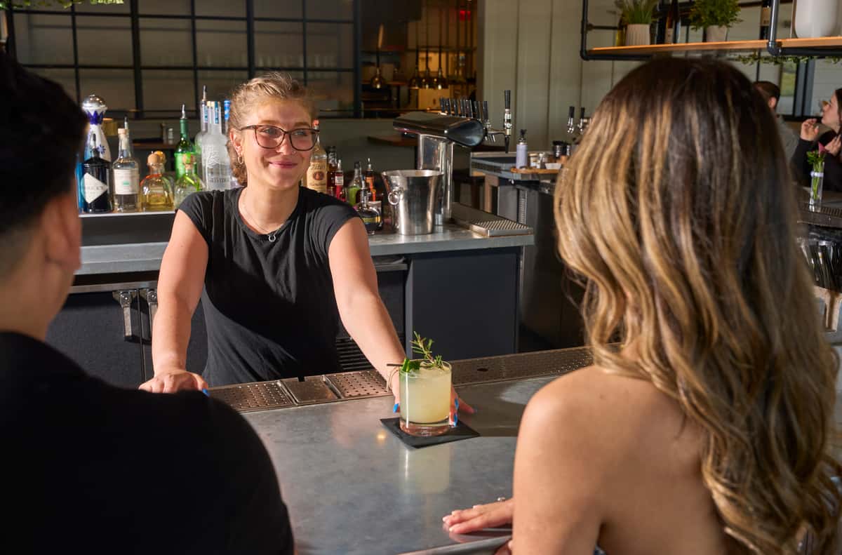 Employee serving a drink