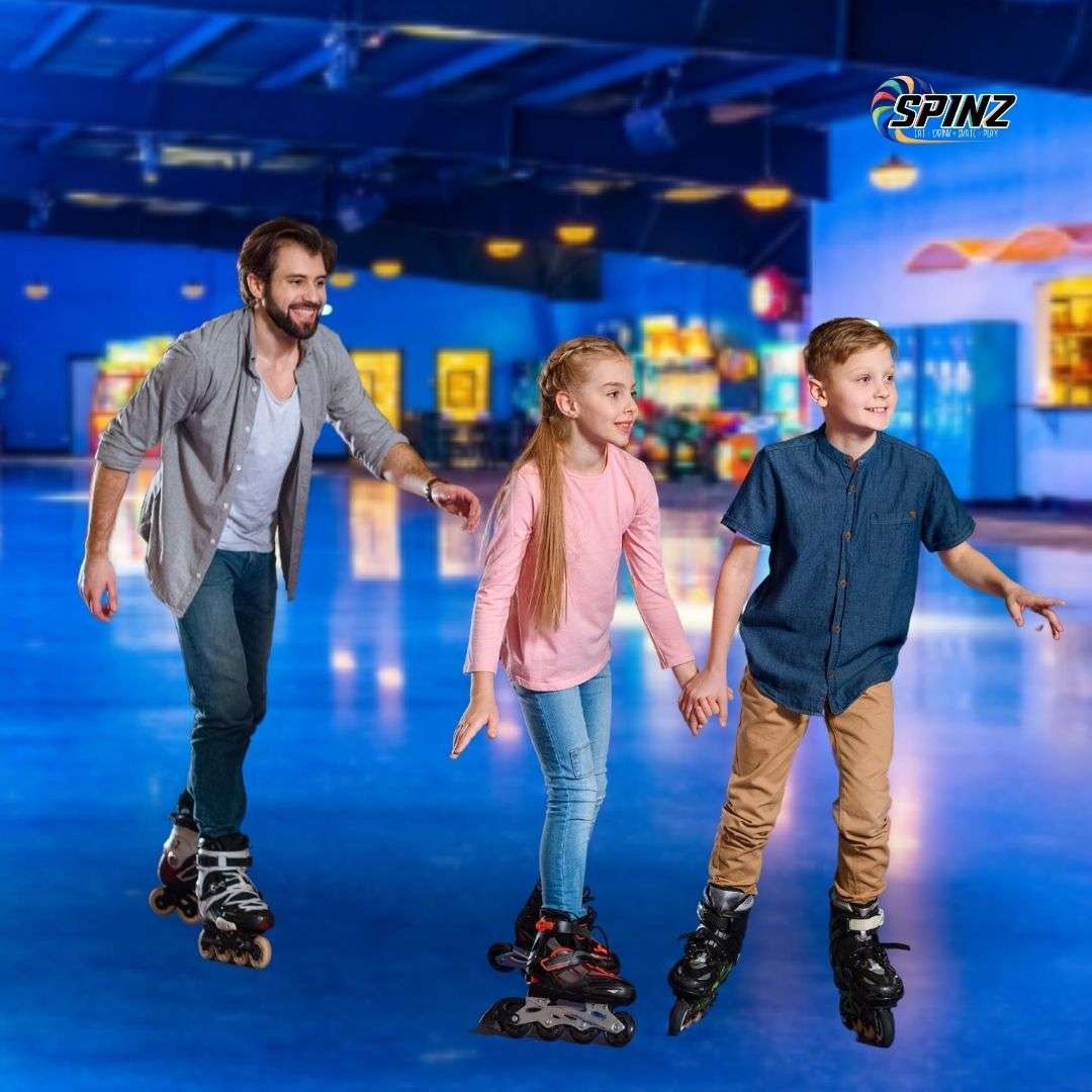 Father and children skating at SPINZ