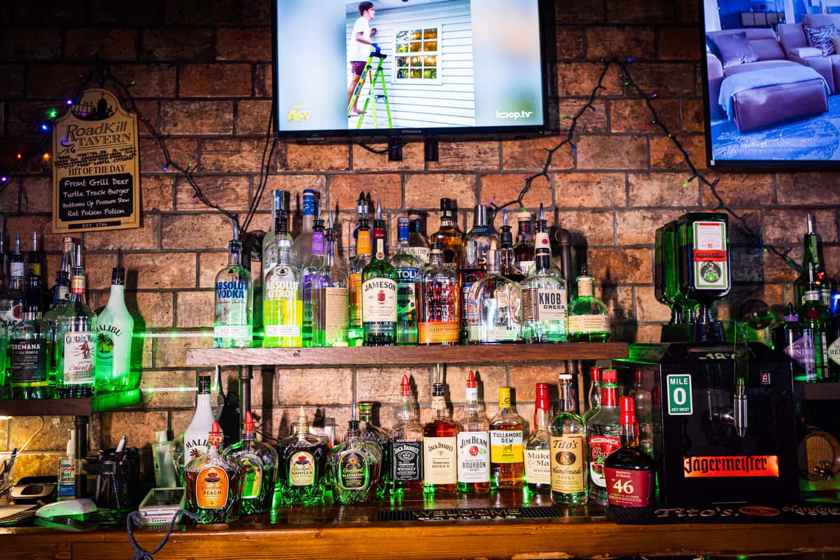 Liquor shelf and red brick wall