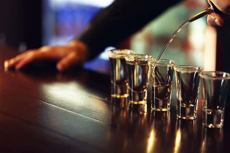 bartender pouring shots of tequila
