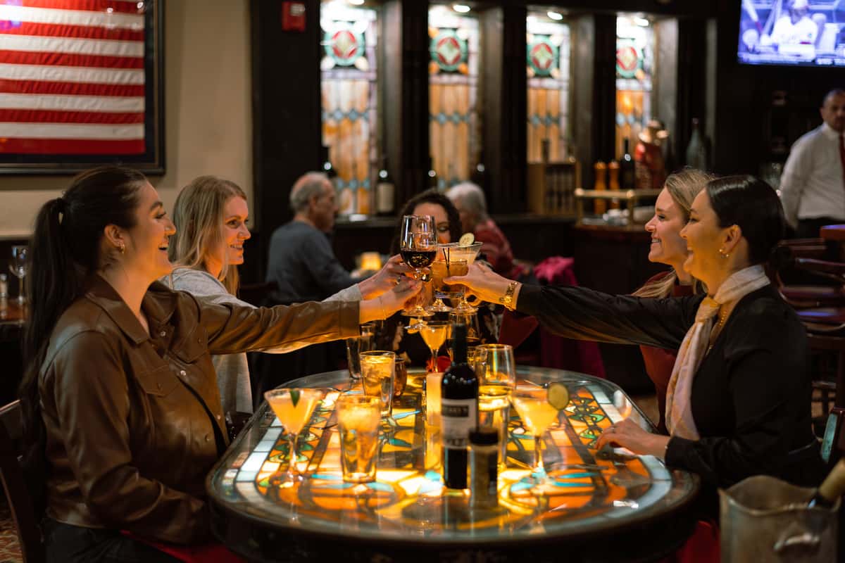 Friends sharing a toast while enjoying dinner together.