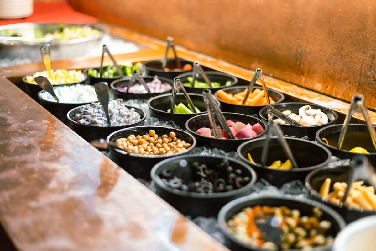 Fresh salad bar featuring a variety of toppings and ingredients.