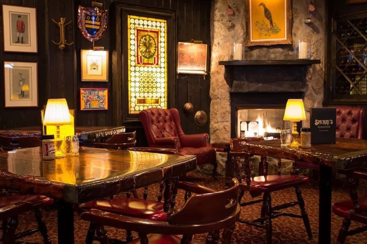 Elegant private dining room with a fireplace, rich wood furnishings, and intimate seating at Sperry's Restaurant.