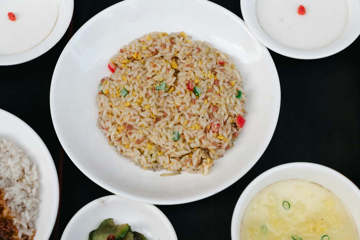 Fried rice surrounded by other dishes