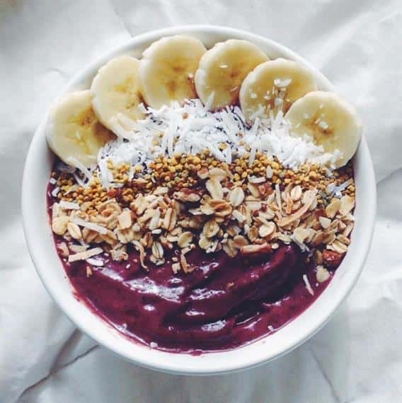 Acai bowl with almonds, granola, bananas, shredded coconut.