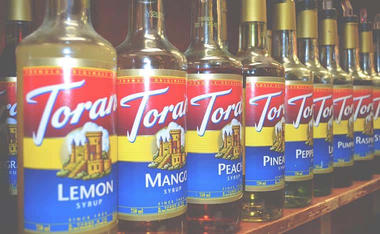 Torani mango syrup bottles on shelf