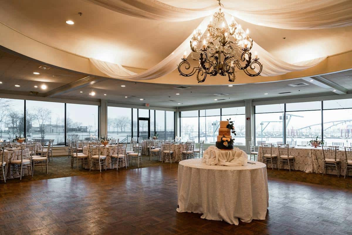 Beautifully decorated dance floor with large chandeliers and draping linens