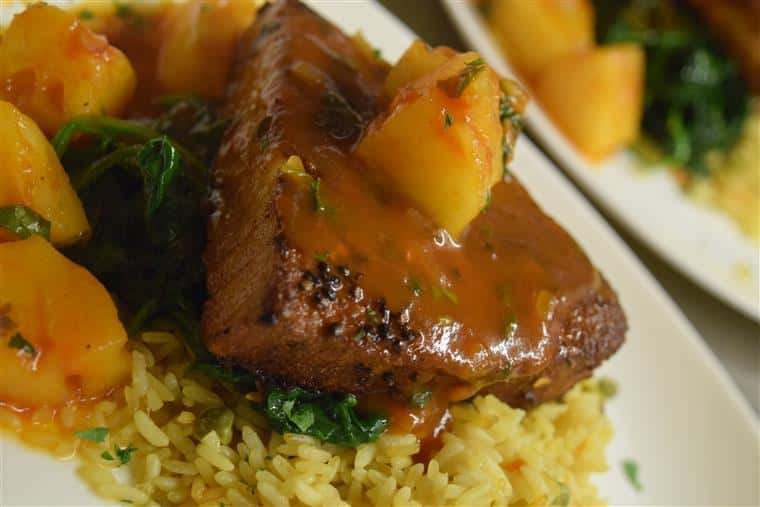 Steak served over rice with roasted potatoes