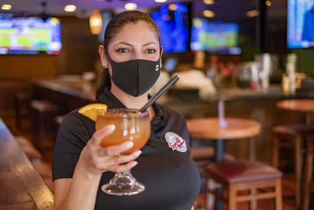 waitress holding a cocktail