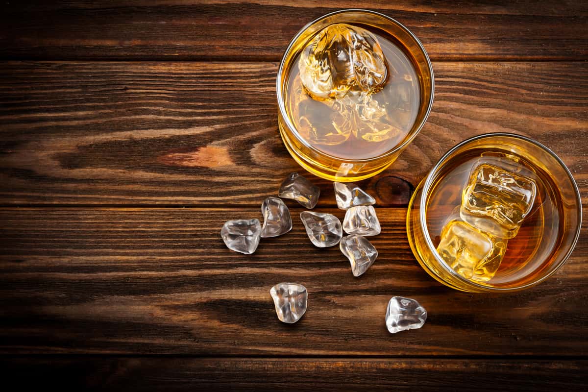 Whiskey glasses on wooden background