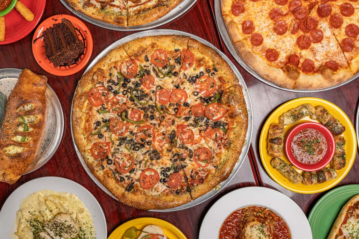 Table full of Italiano's Pizzeria dishes
