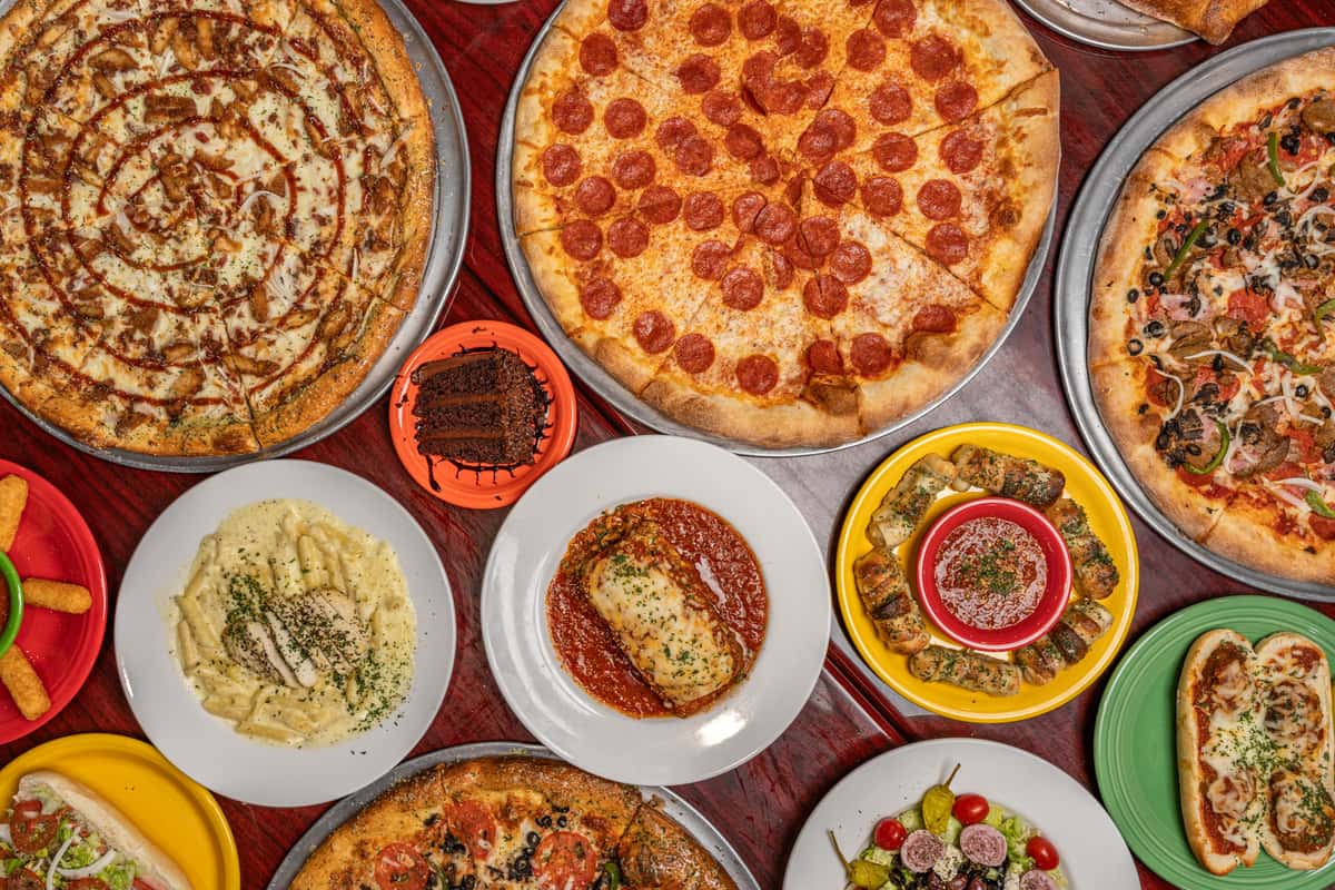spread of pizza, pasta, and other menu items