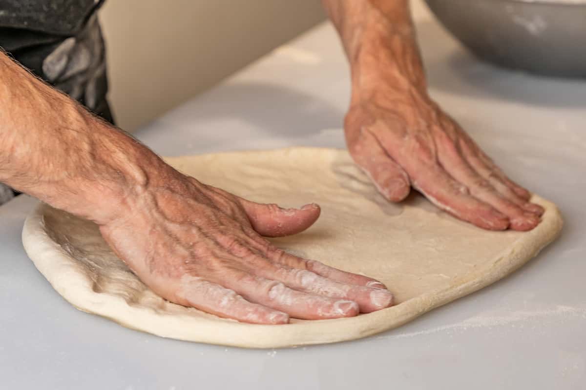 Pizza Chef rolling out dough