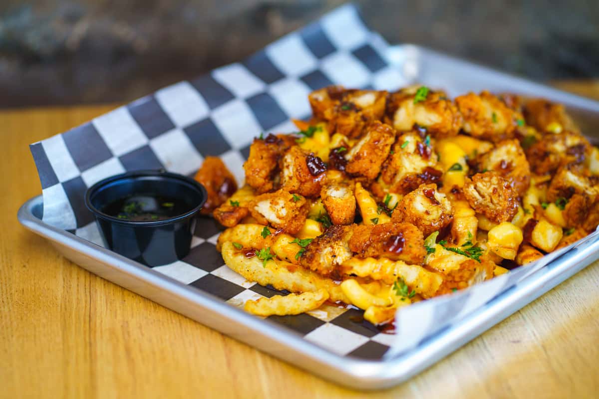 Served over crinkle-cut fries and Nashville hot mac n' cheese. Topped with a whiskey river glaze