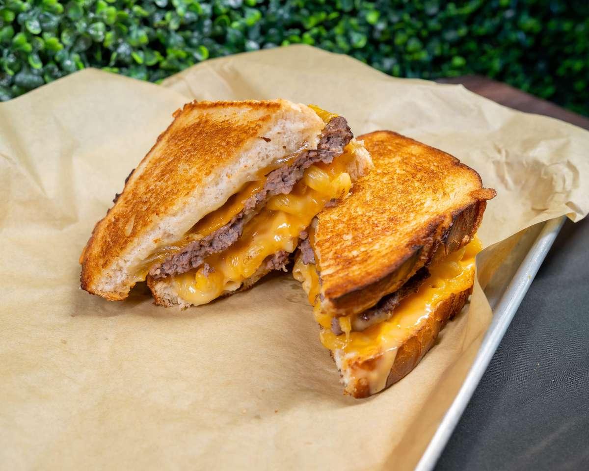 Grilled sandwich halves with melted cheese on a plate