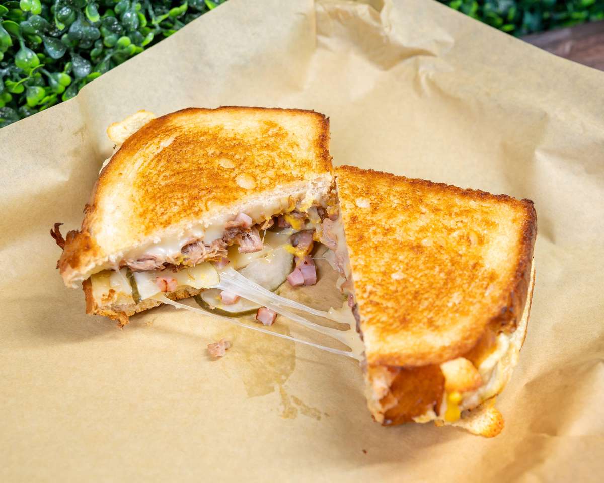 Grilled chicken sandwich halves on parchment paper