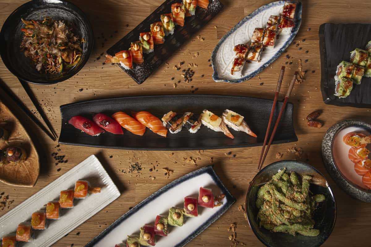 variety sushi nigiri sashimi yakisoba edamame restaurant wooden table