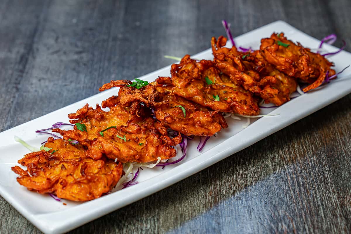 Onion bhaji Indian appetizer – crispy fritters served at Sahib Curry Hill NYC