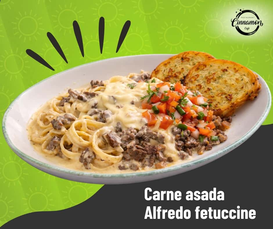 Carne asada Alfredo pasta topped with grilled steak and roasted tomatoes, served with garlic bread.
