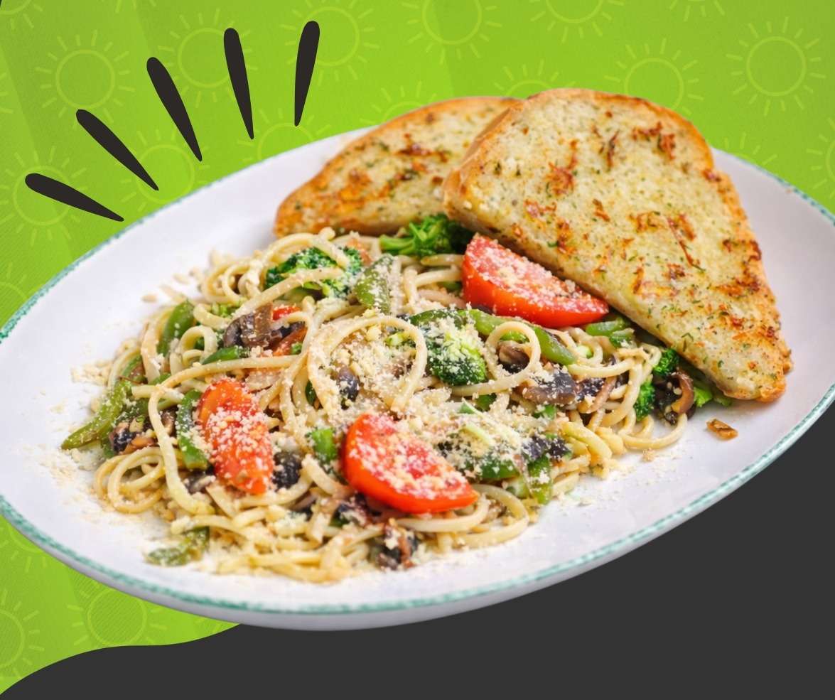 Carne asada Alfredo pasta with grilled steak, creamy parmesan sauce, roasted tomatoes, and garlic bread at Cinnamon Restaurant Café.
