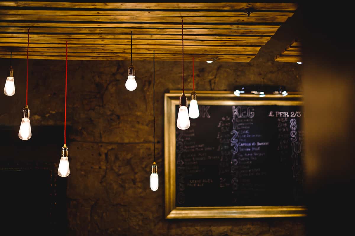 Long string lights hanging from wood ceiling