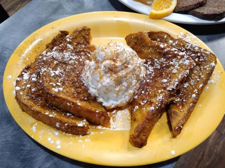 french toast with whipped cream and powdered sugar