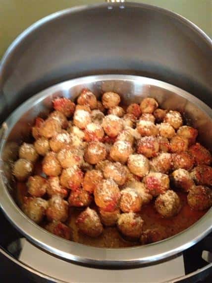 metal sternos filled with meatballs in sauce with grated cheese