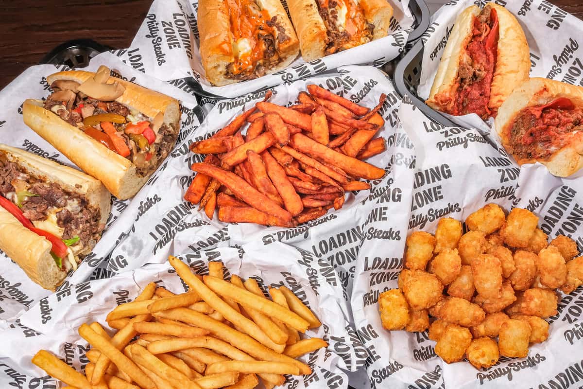 Group of philly steaks, fries and tots