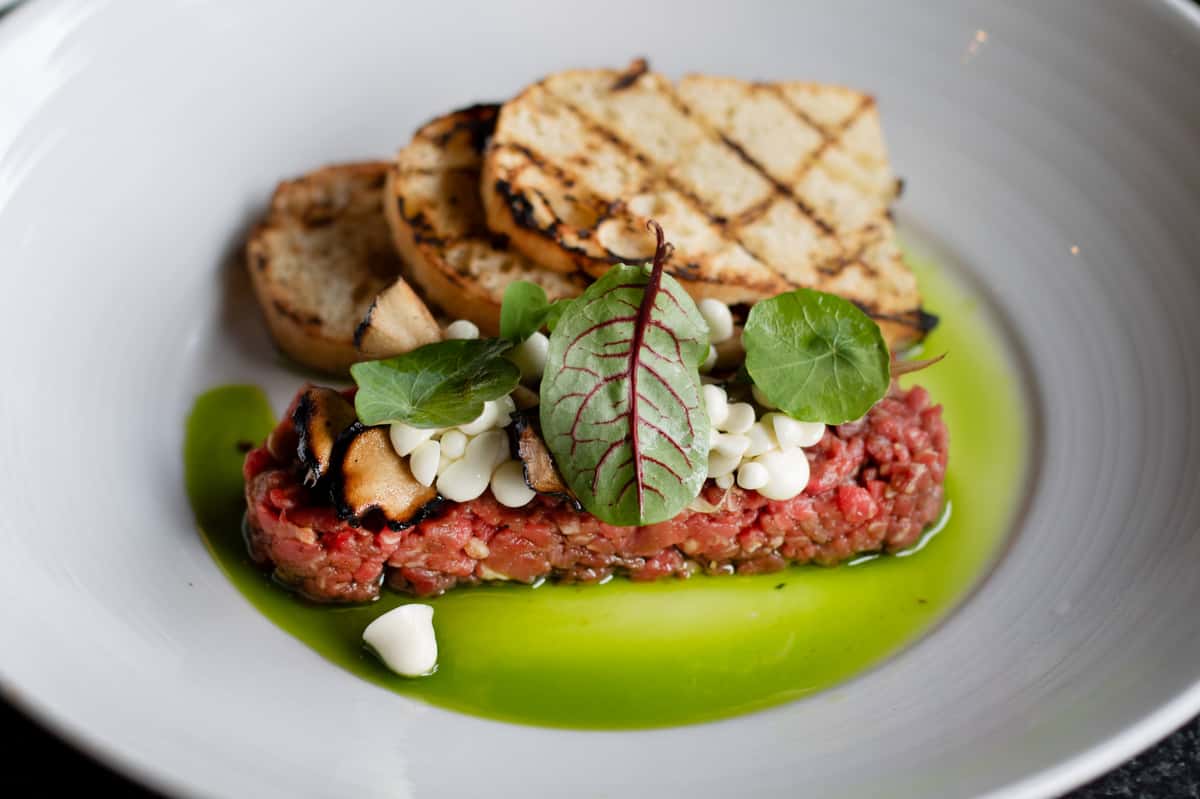 photo of beef, greens, and grilled bread