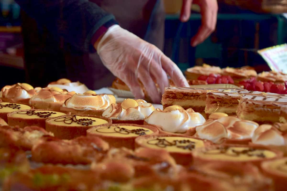 Baker laying out pastries on cooling sheet