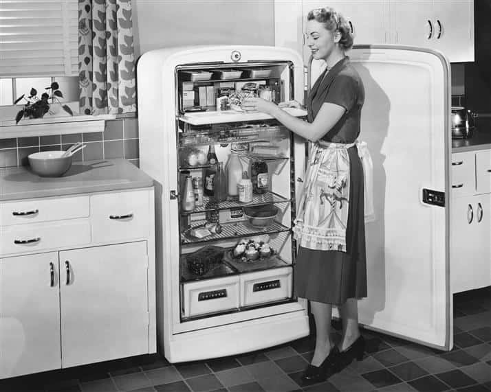 woman standing in front of fridge