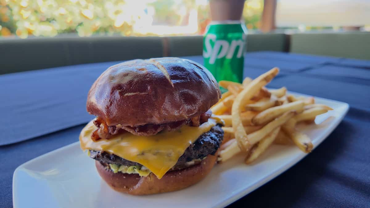 Cheeseburger served with fries and a fountain drink.