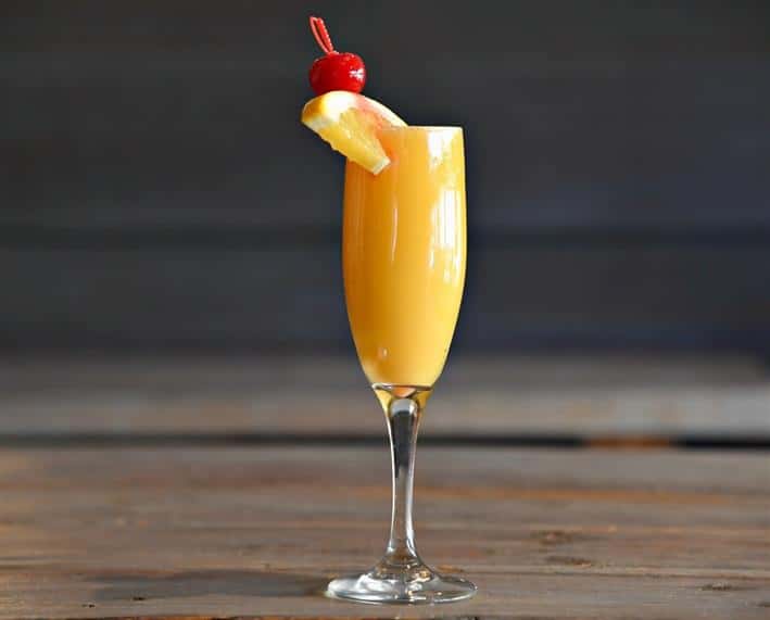 Mimosa topped with an orange and cherry