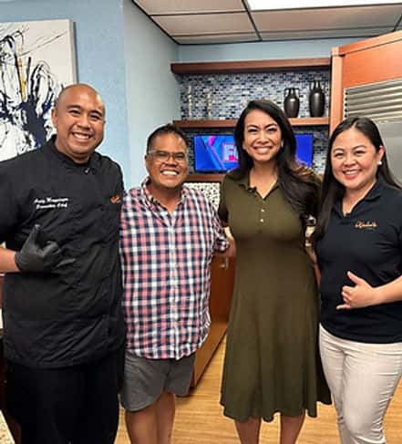 Staff posing for a photo with crew from Fox5